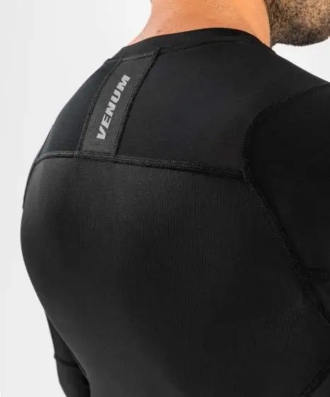 Man wearing Venum G-Fit Air Long Sleeve Rash Guard for workout