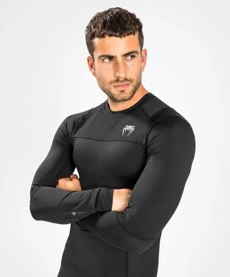 Man wearing the black Venum G-Fit Air Long Sleeve Rash Guard