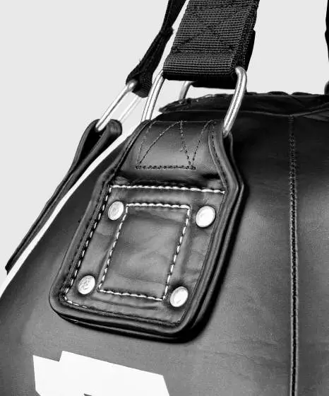 Black and white Venum Hurricane Big Ball Punching Bag hanging in a studio