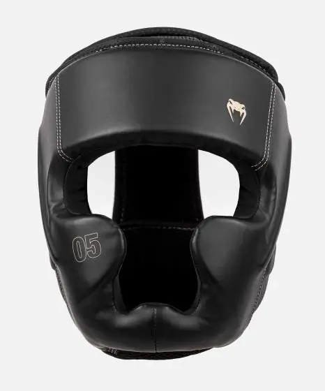 Venum Impact Evo Headgear Protection In Action Athlete preparing for combat sport with Venum Impact Evo Headgear Head Guard