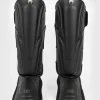 Venum Impact Evo Shinguards in black and red on white background
