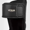 Venum Impact Evo Shinguards in black and white design