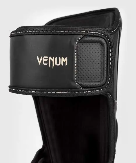 Venum Impact Evo Shinguards in black and white design