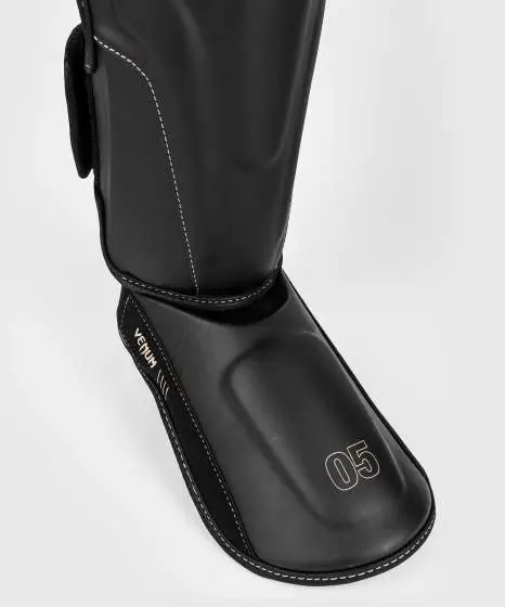 Venum Impact Evo Shinguards on white background