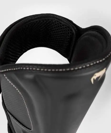 Venum Impact Evo Shinguards in striking black and white design