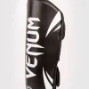 A child wearing Venum Kids Challenger Shin Guards during a martial arts practice.