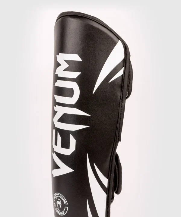 A child wearing Venum Kids Challenger Shin Guards during a martial arts practice.