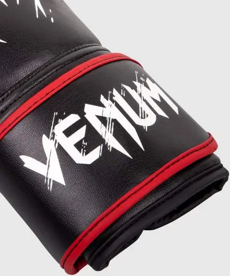 Young child wearing red Venum Kids Contender Boxing Gloves