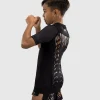 Venum Kids Tiger Short Sleeve Rash Guard Black Orange 2 Young child wearing Venum Kids Tiger Short Sleeve Rash Guard