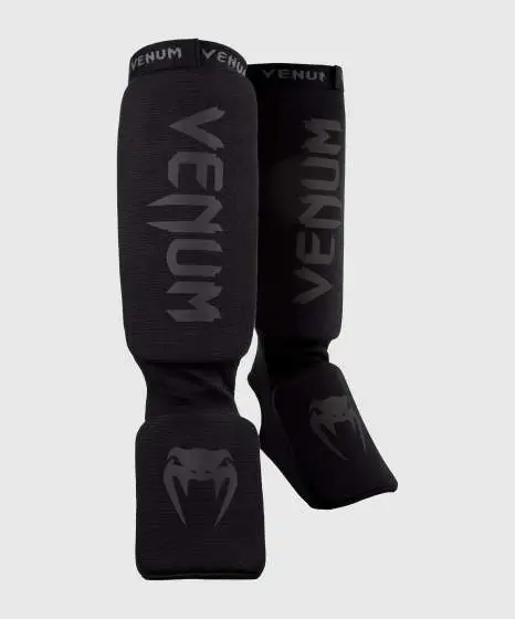 Venum Kontact Cotton Shin Guards in black and white color.
