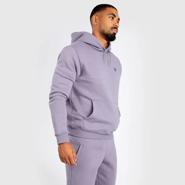 Man wearing Venum Silent Power Hoodie in a gym setting