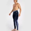 A man wearing Venum Tempest Men's Spats Compression Tights for sports activity.