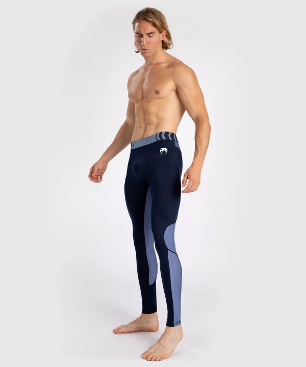 A man wearing Venum Tempest Men's Spats Compression Tights for sports activity.