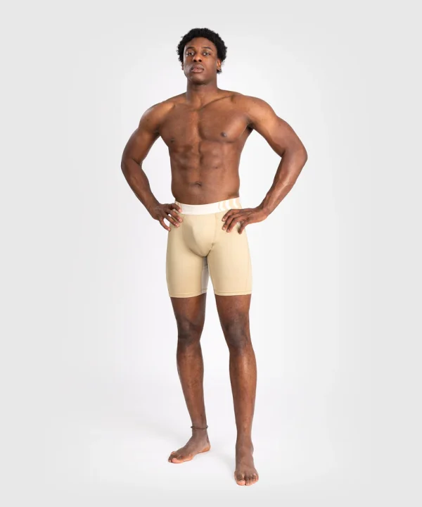 Venum Tempest Mens Vale Tudo Shorts Beige Sand 1 Man wearing Venum Tempest Men's Vale Tudo Shorts