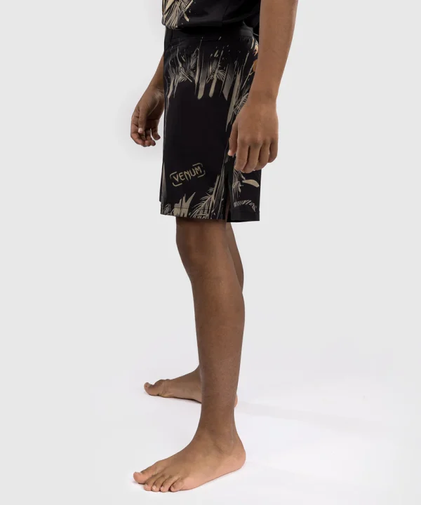 Venum Tiger Kids Fight Shorts Black Orange 1 Young boy wearing Venum Tiger Kids Fight Shorts