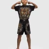 Venum Tiger Kids Fight Shorts Black Orange 5 A child wearing Venum Tiger Kids Fight Shorts