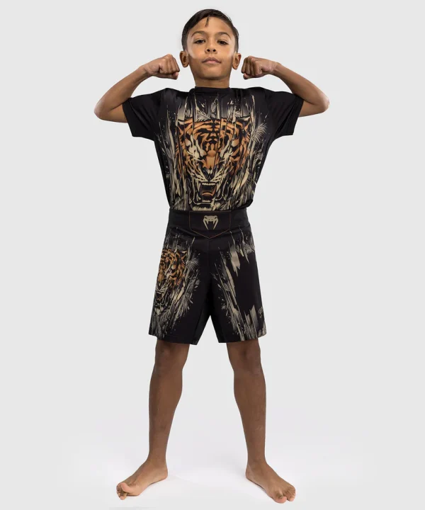 Venum Tiger Kids Fight Shorts Black Orange 5 A child wearing Venum Tiger Kids Fight Shorts