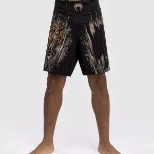 A kid wearing Venum Tiger Kids Fight Shorts