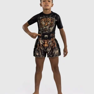 Kid wearing Venum Tiger Muay Thai Shorts