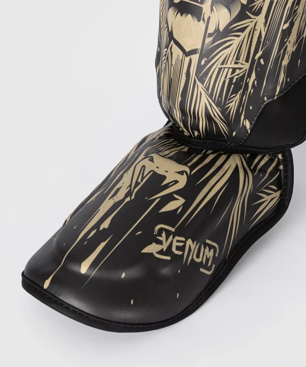 Venum Tiger Shin Guards on a white background