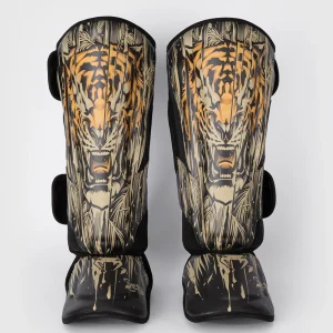 Venum Tiger Shin Guards on white background