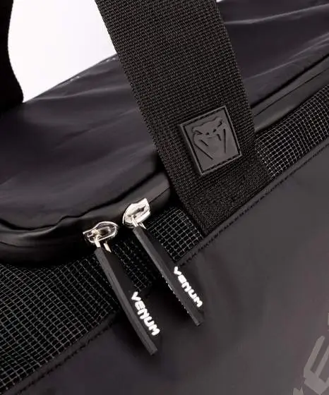 Venum Trainer Lite Evo Sports Duffle Bag Black 5 Venum Trainer Lite Evo Sports Duffle Bag in a gym setting