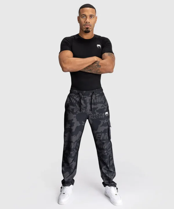 Venum Trooper Mens Tracksuit Bottoms Pants Black Charcoal 5 Man wearing Venum Trooper Men's Tracksuit Bottoms Pants
