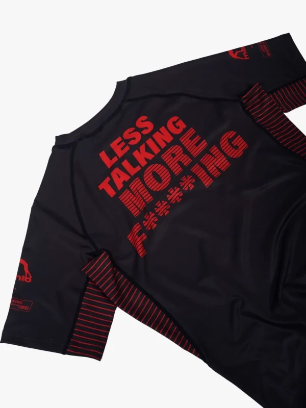 Martial artist wearing Manto Less Talking More Fighting Rash Guard