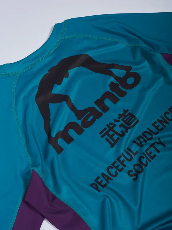 Manto Society Rash Guard on white background