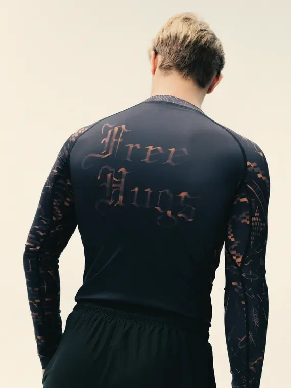 Manto Long Sleeve Rash Guard - Free Hugs Design A Manto Free Hugs Long Sleeve Rash Guard displayed on a white background