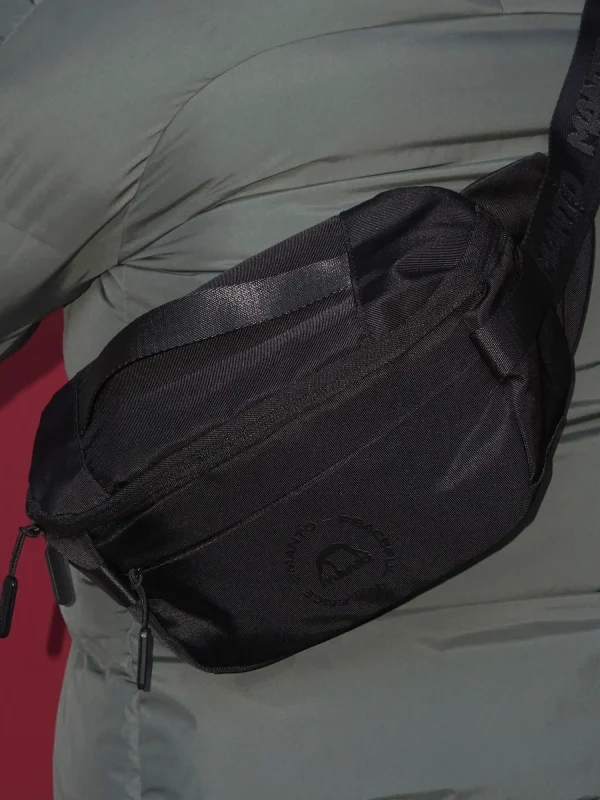 Manto Circle Logo Waist Bag Black 9 Manto Circle Logo Waist Bag in a light backdrop.