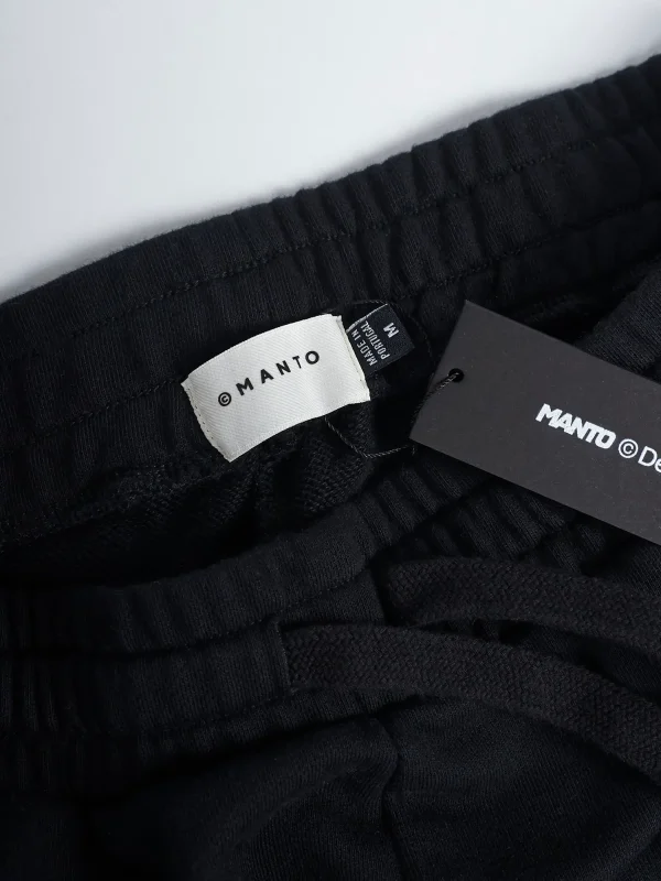 Manto Fight Company Sweatpants on a plain background
