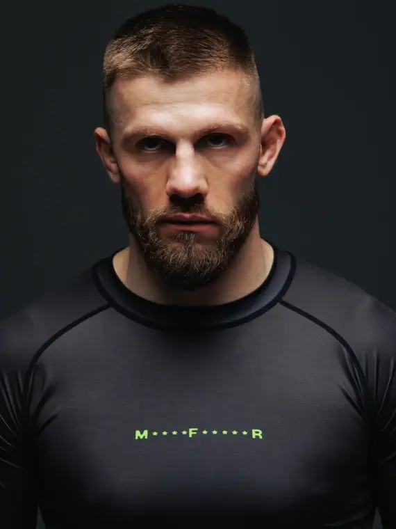 Black and red Manto Fighter Rash Guard on plain background