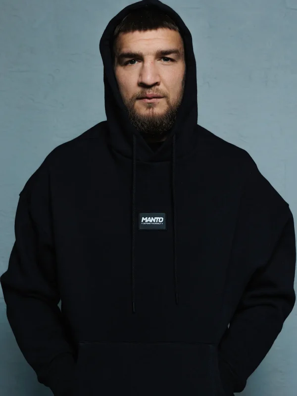 Male model wearing a Manto Label Oversize Hoodie in a urban setting