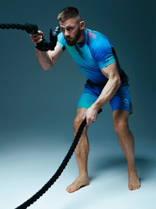 A man wearing Manto Society Gradient Fight Shorts in a training session.