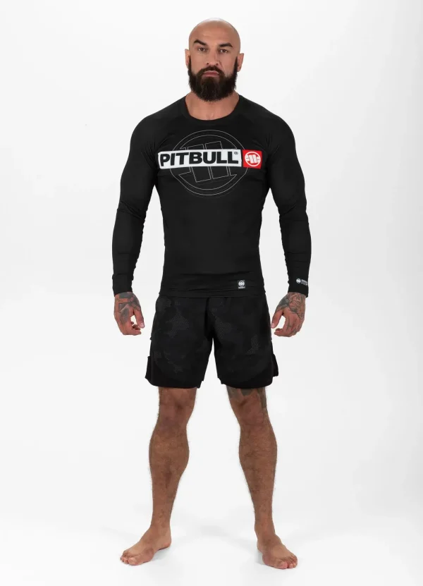 Pitbull Hilltop Sports Longsleeve Rash Guard Black 10 Active male wearing 'Pitbull Hilltop Sports Longsleeve Rash Guard' in an outdoor setting.