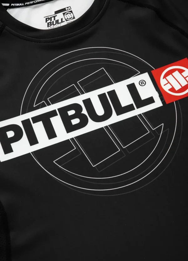 Pitbull Hilltop Sports Longsleeve Rash Guard Black 2 Man posing in a "Pitbull Hilltop Sports Longsleeve Rash Guard", perfect for outdoor sports.