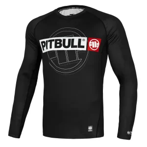 Pitbull Hilltop Sports Longsleeve Rash Guard. Man wearing a 'Pitbull Hilltop Sports Longsleeve Rash Guard' in a casual setting.