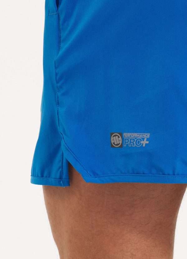 Pitbull Sports Shorts Performance Pro Plus Small Logo Ii Blue 5 Man modeling Pitbull Sports Shorts Performance Pro Plus Small Logo II, designed for athletic comfort and style.