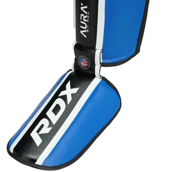 Pair of RDX Shin Guards Aura Plus T-17 on white background