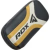 Pair of RDX T-17 Aura Plus Kick Pads lying on a gym floor
