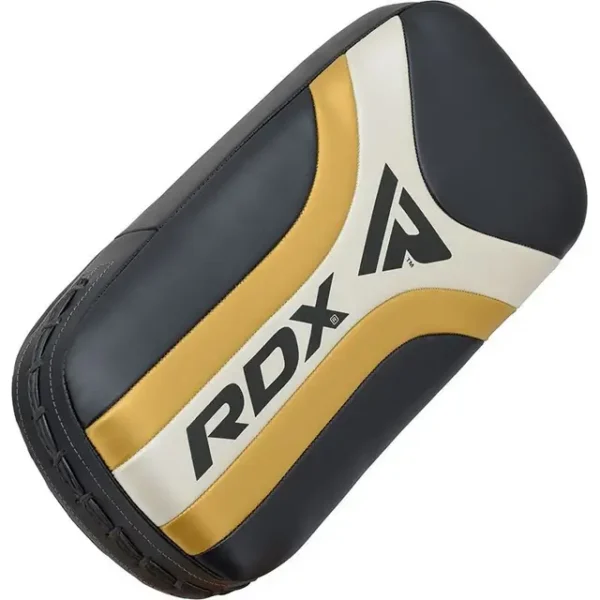 Pair of RDX T-17 Aura Plus Kick Pads lying on a gym floor