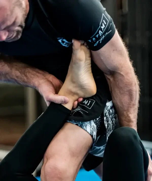 Athletic male wearing Tatami Fightwear Kanagawa Shorts for martial arts