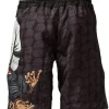 Man wearing Tatami Fightwear Thinker Monkey Shorts with martial arts training background.