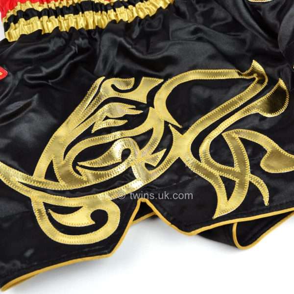 Twins Special Muay Thai Shorts TWS-154 - Black/Gold in Black/Gold — three‑quarter angle