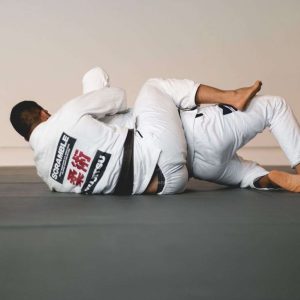 A fighter in a Scramble BJJ Gi locks in back control during jiujitsu sparring