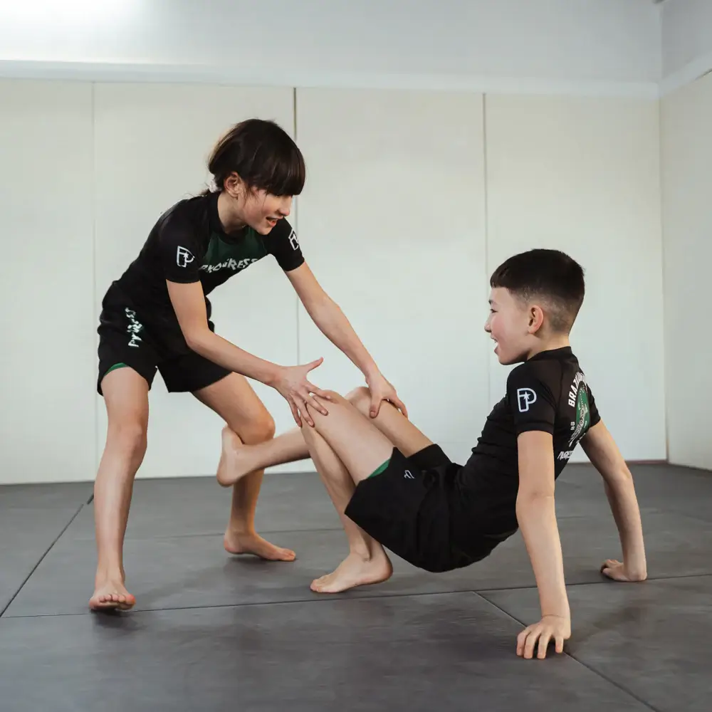 Two kids sparring No-gi BJJ wearing Kids Fight and training shoes