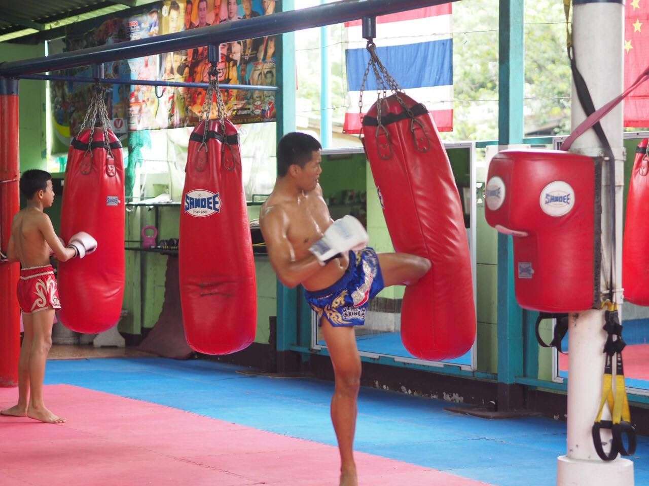 A man strikes a Muay Thai and Kickboxing punch bag