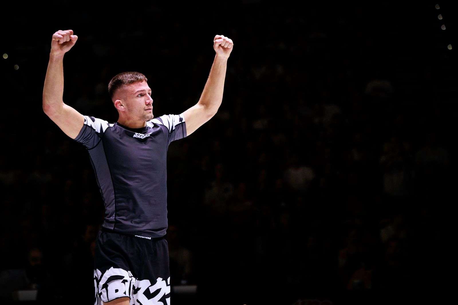 A victorious grappler in the matching scramble Rashguard and shorts baka set