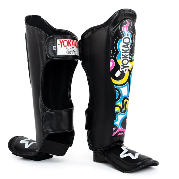 Yokkao Flames Shin Guards Black Multicolour 2 Yokkao Flames Shin guards - Black/Multicolour in Black/Multicolour — flat lay